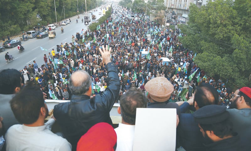 Karachi Jamaat-i-Islami chief Hafiz Naeem ur Rehman waves his hand to participants in a rally taken out on Sharea Faisal against the controversial local government law on Sunday.—Shakil Adil /White Star