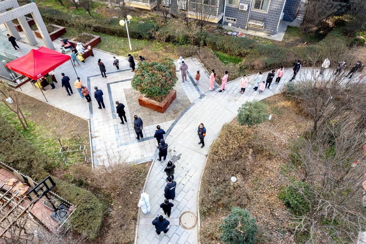 People line up during the fifth round of nucleic acid testing at a residential compound following the coronavirus outbreak in Anyang, Henan province, China, January 15. — Reuters