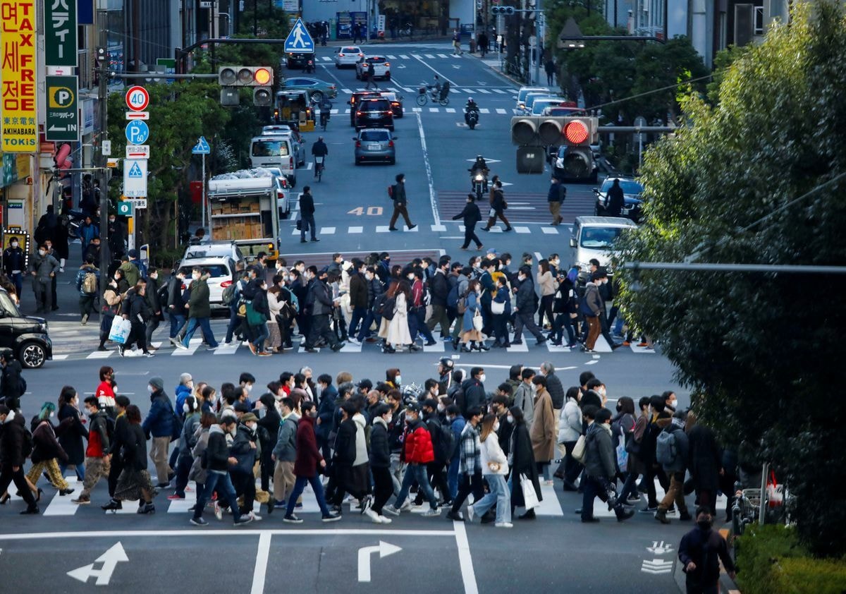 Passersby wearing protective face masks walk on the street, amid the coronavirus pandemic, in Tokyo, Japan, January 15. — Reuters