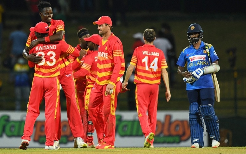 Zimbabwe's players celebrate their victory at the end of the second ODI match between Sri Lanka and Zimbabwe at the Pallekele International Cricket Stadium in Kandy on Tuesday. — AFP