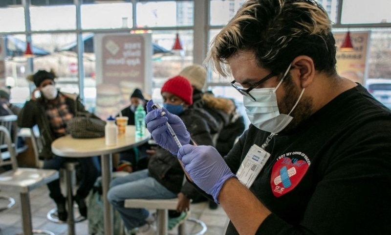 A worker from Chicago Family Health Centre prepares a booster shot for the coronavirus at a McDonald's, as the Omicron coronavirus variant spreads through the country, in Chicago, Illinois, US, December 21. — Reuters