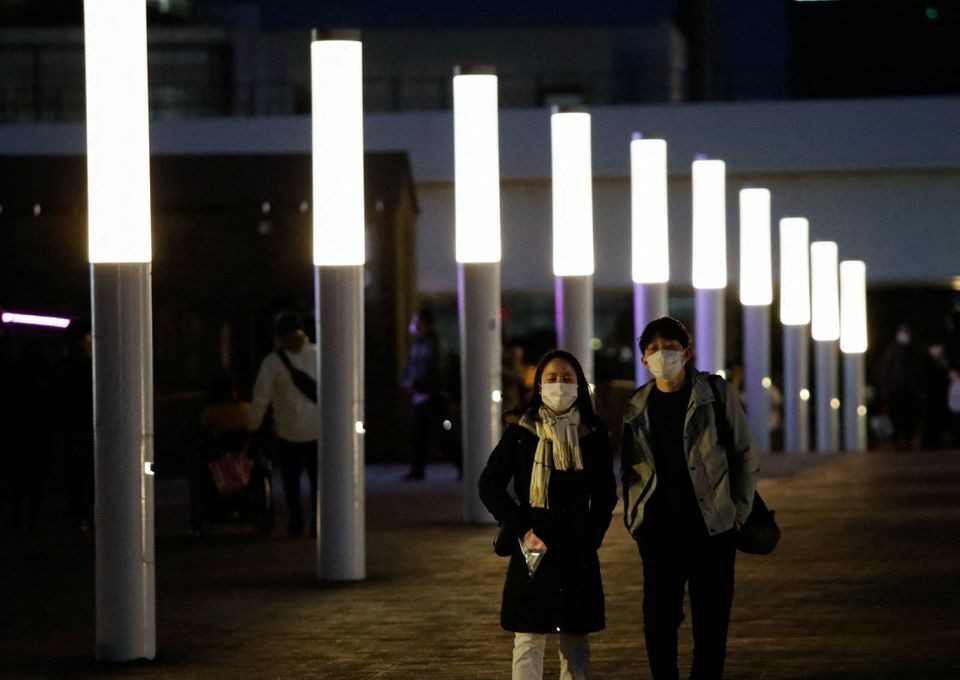 Visitors wearing protective face masks stroll at the Odaiba district, amid the coronavirus pandemic, in Tokyo, Japan, January 22. — Reuters