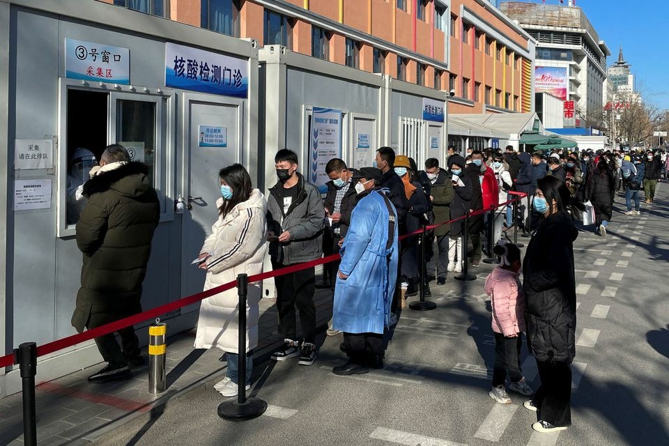 People line up to take nucleic acid tests at a testing site outside a hospital following the coronavirus outbreak in Beijing, China, January 17. — Reuters