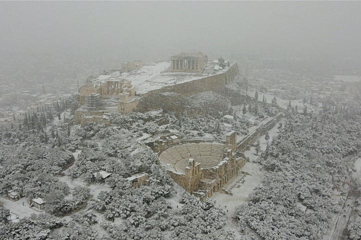 A view of the Parthenon temple atop the Acropolis hill during heavy snowfall on Monday. —Reuters