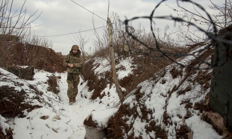 A service member of the Ukrainian armed forces walks at combat positions near the line of separation from Russian-backed rebels near Horlivka in the Donetsk region, Ukraine, January 22. — Reuters