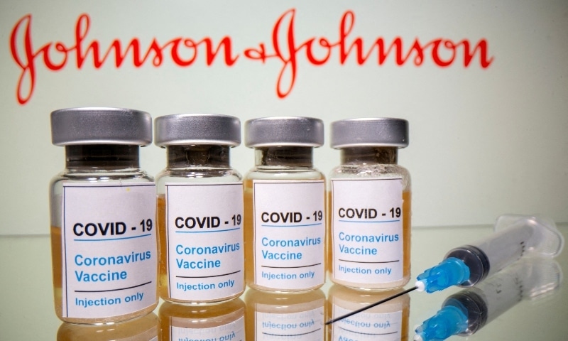 Vials and a medical syringe are seen in front of a displayed Johnson & Johnson logo in this illustration taken October 31, 2020. — Reuters
