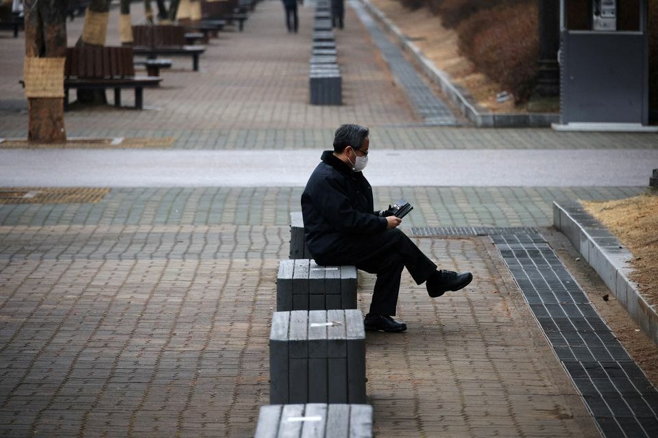 A man wearing a mask to prevent contracting the coronavirus rests at an empty park in Seoul, South Korea, January 25. &mdash; Reuters