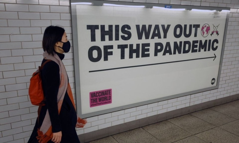 A woman walks past a sign amidst the spread of the coronavirus in London, Britain, January 24. — Reuters