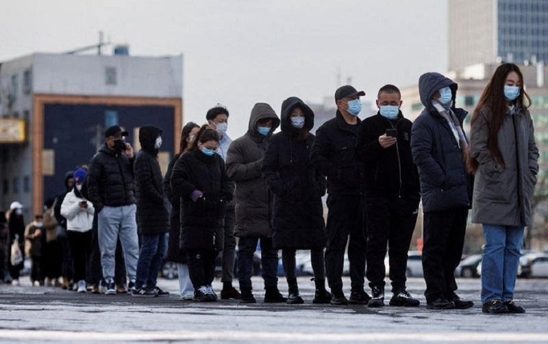People line up to get a throat swab test at a temporary Covid-19 testing center as the coronavirus disease continues in Beijing on Wednesday. — Reuters