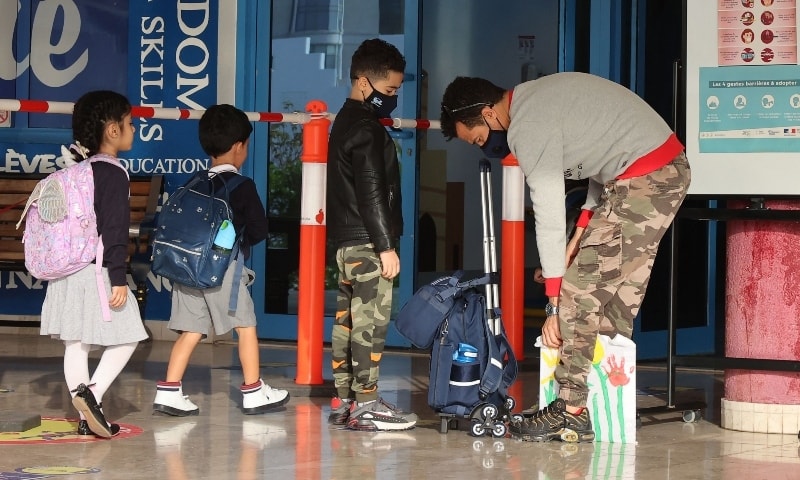 A Qatari security guard checks the bag of a school boy before entering his classroom at the French Lycee in Doha on January 30. &mdash; AFP