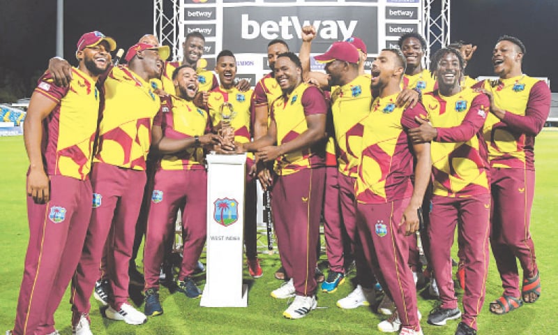 BRIDGETOWN: West Indies players pose with the trophy after the final T20 International against England at the Kensington Oval.—AFP BRIDGETOWN: West Indies players pose with the trophy after the final T20 International against England at the Kensington Oval.—AFP