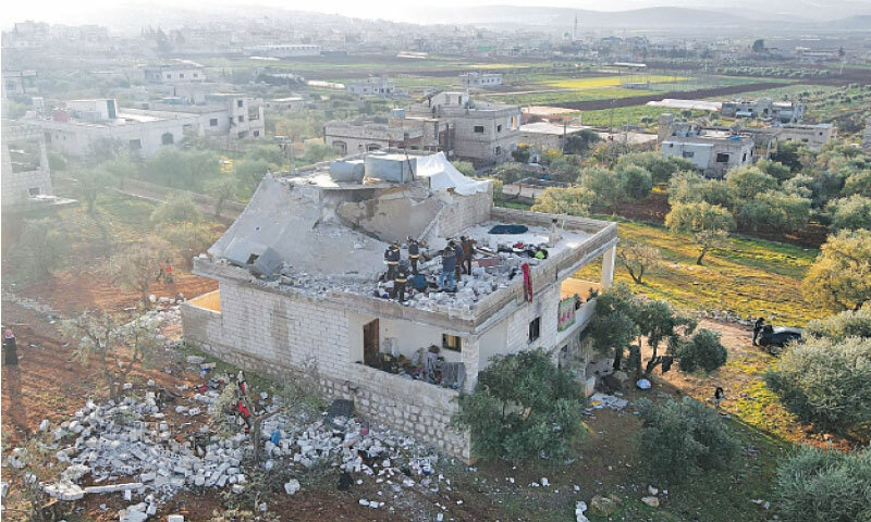 SYRIANS gather at the scene of a deadly raid by US special forces against suspected militants in northwestern Syria.—AFP SYRIANS gather at the scene of a deadly raid by US special forces against suspected militants in northwestern Syria.—AFP