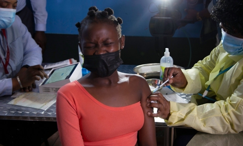 A young woman reacts as she receives her Pfizer vaccine against Covid-19 in Diepsloot Township near Johannesburg on Feb 3. &mdash; AP