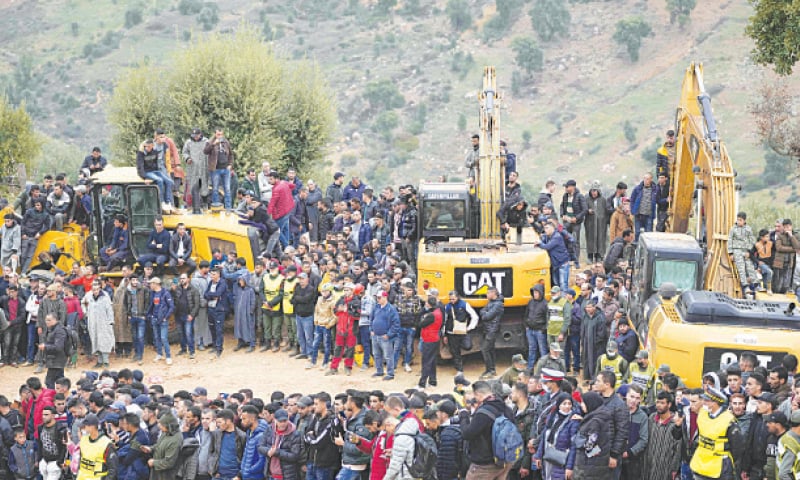 Residents stand on top of tractors as they watch civil defence workers and local authorities attempting to rescue a five-year-old boy who fell into a hole in the northern village of Ighran in Morocco&rsquo;s Chefchaouen province.&mdash;AP