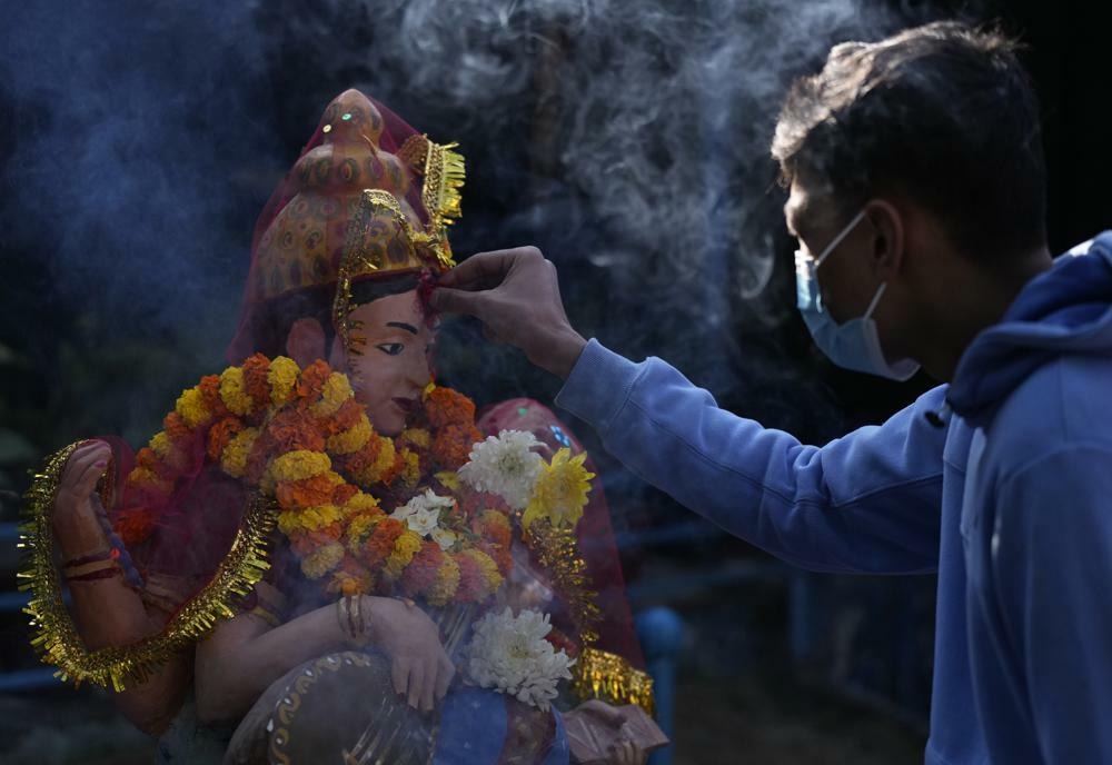 A Nepalese student offers prayers before a statue of Hindu goddess Saraswati at a school during Shri Panchami festival in Kathmandu, Nepal, Feb 6. — AP