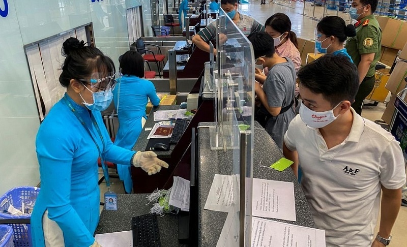 In this file photo, passengers wearing protective face masks check-in at Noi Bai International Airport, in Hanoi, Vietnam on October 10, 2021. &mdash; Reuters/File