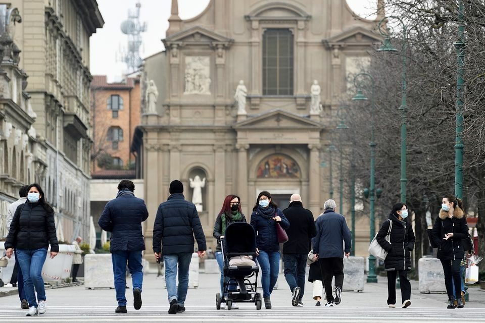 People walk at a street a year after the peak of Italy's coronavirus outbreak in Bergamo on March 3, 2021. &mdash; Reuters
