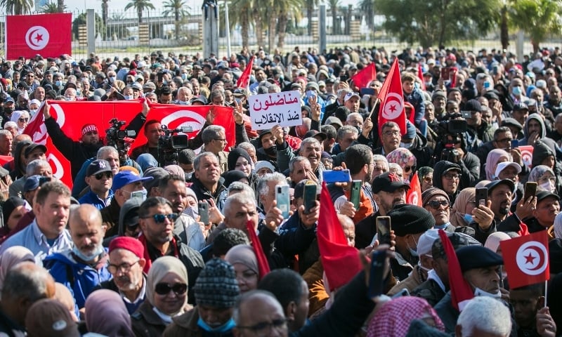 A demonstrator holds a placard with a message written in Arabic reading, “Activists against the coup” during a protest against Tunisian President Kais Saied in Tunis, Tunisia, Feb 13. — AP A demonstrator holds a placard with a message written in Arabic reading, “Activists against the coup” during a protest against Tunisian President Kais Saied in Tunis, Tunisia, Feb 13. — AP