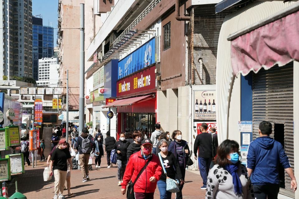 Pedestrians wearing facemasks walk on a street, following the coronavirus outbreak in Hong Kong, China, February 14. &mdash; Reuters