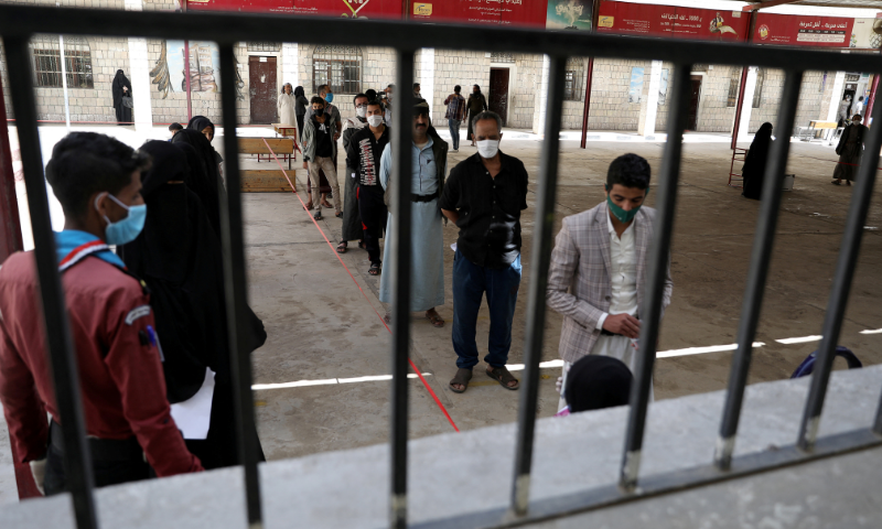 People stand in line to receive vouchers at a food distribution centre supported by the World Food Programme in Sanaa, Yemen. — Reuters/File