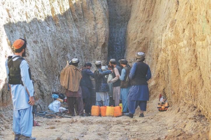 RESCUERS try to reach and rescue the boy trapped for two days down a well in a village in Zabul province.&mdash;AFP