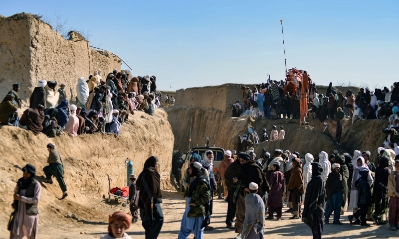Afghan people gather as rescuers try to reach and rescue a boy trapped for two days down a well in a remote southern Afghan village of Shokak, in Zabul province on February 17. — AFP Afghan people gather as rescuers try to reach and rescue a boy trapped for two days down a well in a remote southern Afghan village of Shokak, in Zabul province on February 17. — AFP