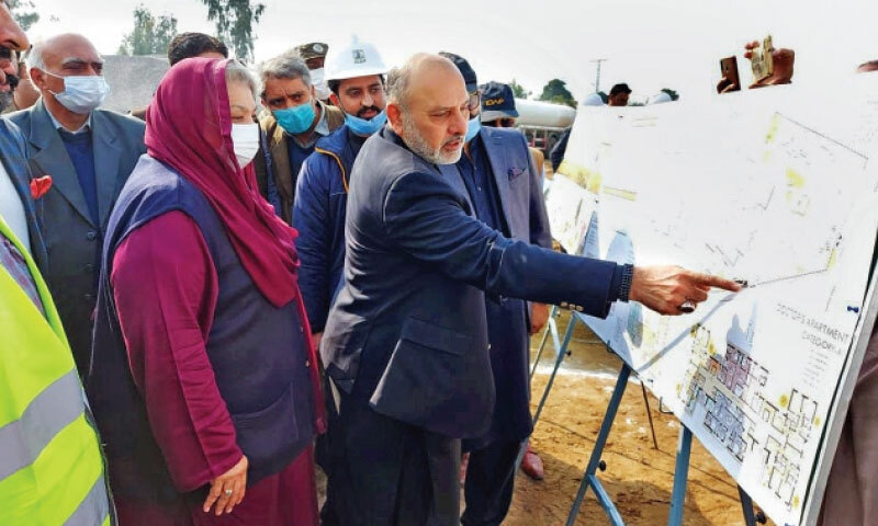 Punjab Minister for Specialised Healthcare and Medical Education Dr Yasmin Rashid being briefed at the site of the Mother and Child Hospital in Attock on Friday. &mdash; Dawn