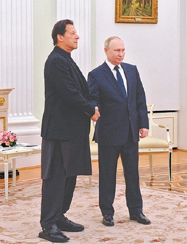 RUSSIAN President Vladimir Putin and Prime Minister Imran Khan shake hands before their meeting in Kremlin on Thursday.—AP