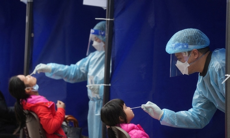 Medical workers take swab samples from residents at a community nucleic acid testing centre for Covid-19 at Sha Tin district in Hong Kong on February 7. — Reuters