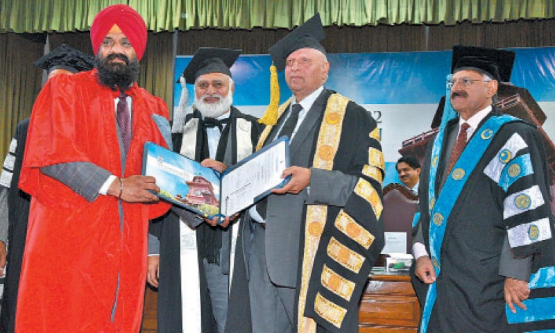 Governor Chaudhry Sarwar awards PhD degree to Sikh graduate Dr Kalyan Singh Kalyan at the Punjab University convocation. &mdash; Dawn