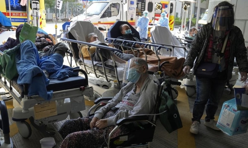 Patients wait at a temporary treatment area outside Caritas Medical Centre in Hong Kong, China, Feb 26. — AP