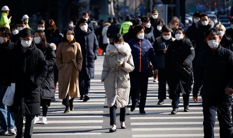 In this file photo, commuters cross a zebra crossing, amid the Covid-19 pandemic in Seoul, South Korea on Feb 3, 2021. — Reuters