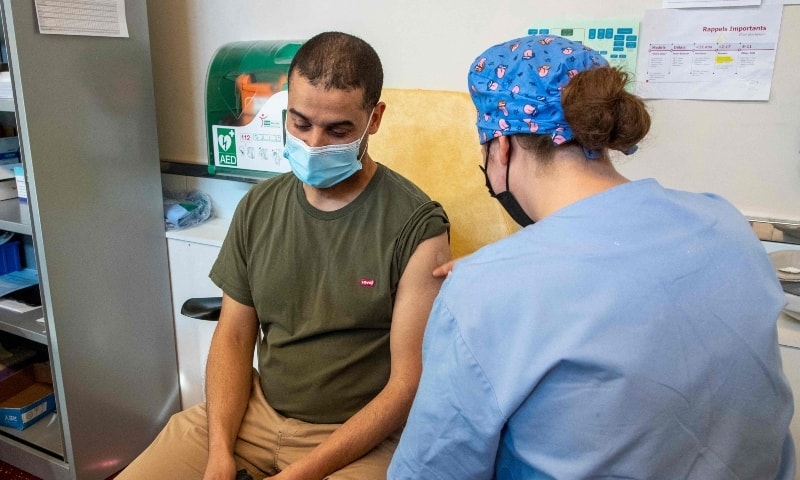 A person receives a Nuvaxovid vaccine at the Pacheco test and vaccination centre in Brussels on March 3. &mdash; AFP