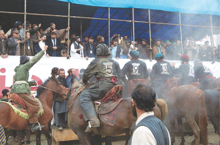 Horsemen from the Kandahar team celebrate their victory over the Kunduz team after the final tie of Afghanistan’s Buzkashi League on Sunday.—AFP Horsemen from the Kandahar team celebrate their victory over the Kunduz team after the final tie of Afghanistan’s Buzkashi League on Sunday.—AFP