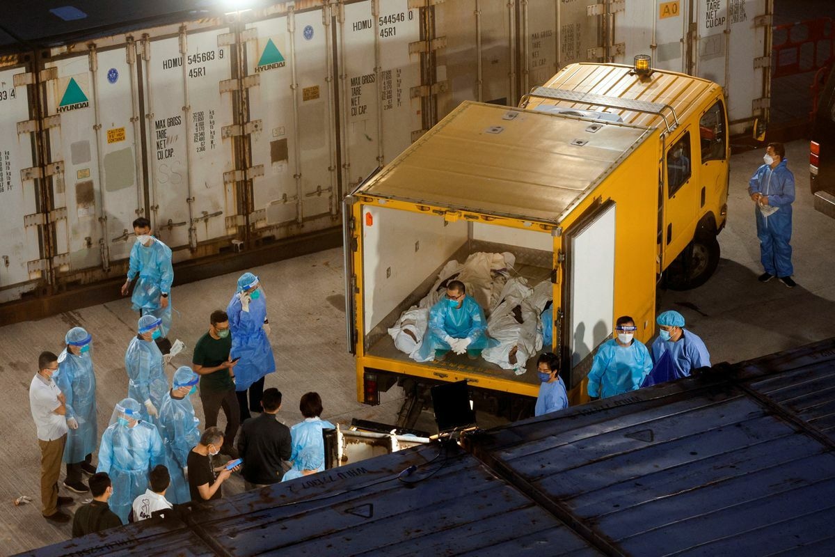 Corpses are moved to a refrigerated container outside a funeral home, as mortuaries run out of space amid the coronavirus outbreak in Hong Kong, China, March 5. &mdash; Reuters