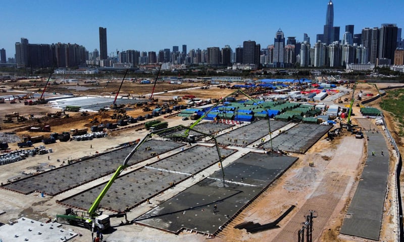 A general view of the high-rise buildings in Shenzhen and construction site of a Covid-19 isolation facility in Lok Ma Chau. &mdash; Reuters