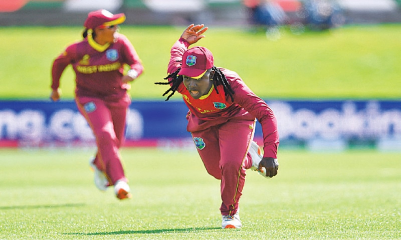 WEST INDIES&rsquo; Deandra Dottin celebrates after taking a successful catch to dismiss England batter Lauren Winfield-Hill during their Women&rsquo;s World Cup match at the University Oval on Wednesday.&mdash;AFP