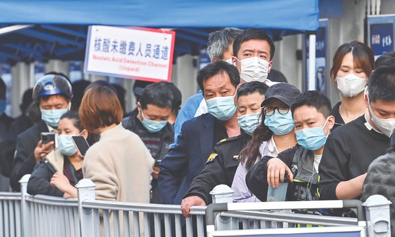 SHANGHAI: People queue up in front of a hospital on Friday so they could be tested for Covid-19.—AFP