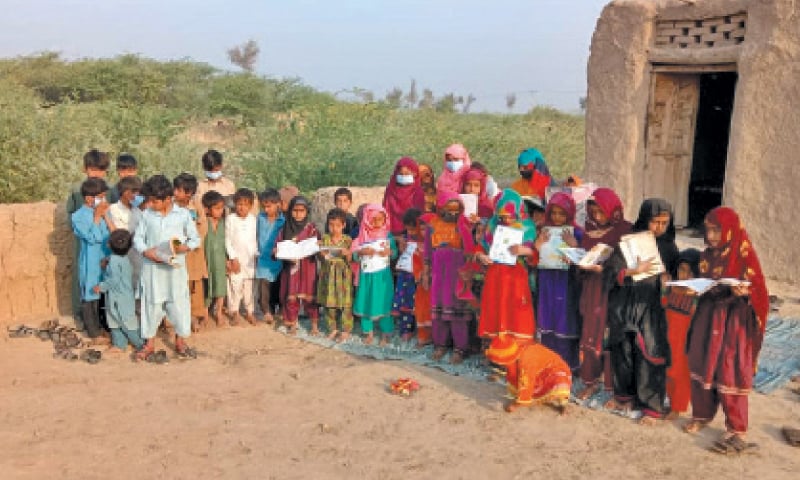DERA GHAZI KHAN: Children stand in the courtyard of their makeshift school at village Thoul Chaang of Rajanpur district. — Dawn DERA GHAZI KHAN: Children stand in the courtyard of their makeshift school at village Thoul Chaang of Rajanpur district. — Dawn