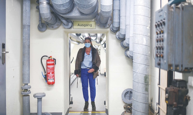 COCHEM (Germany): Petra Reuter, owner of the Bundesbank Bunker Museum, walks through an underground passage in a former vault.&mdash;AFP