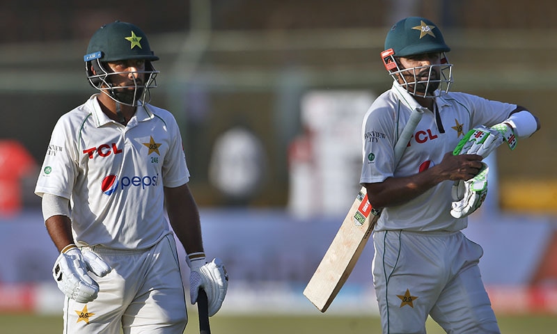 Pakistan's Babar Azam, left, and Abdullah Shafique leave the ground after end of the fourth day play of the second test match between Pakistan and Australia at the National Stadium in Karachi on Tuesday. — AP