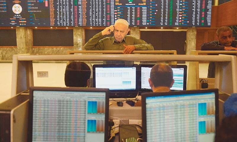 In this file photo, stockbrokers are monitoring share prices at the Pakistan Stock Exchange.&mdash;AFP