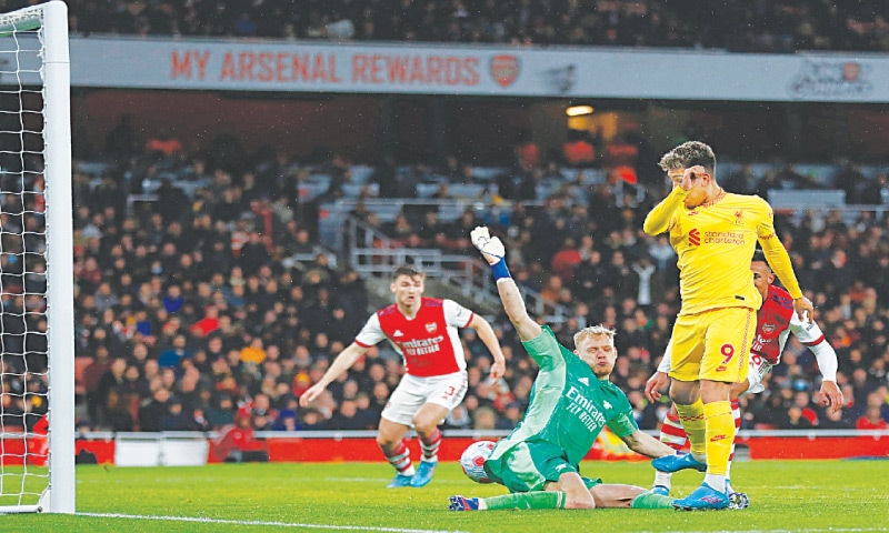 LONDON: Liverpool&rsquo;s Roberto Firmino scores past Arsenal goalkeeper Aaron Ramsdale during their Premier League match at the Emirates Stadium.&mdash;AFP