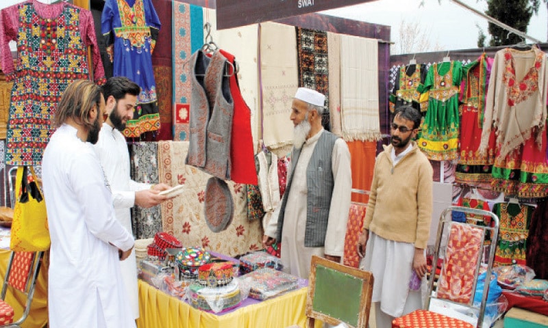 PEOPLE visit a stall at the Miandam Cultural Festival, Swat. &mdash; Dawn