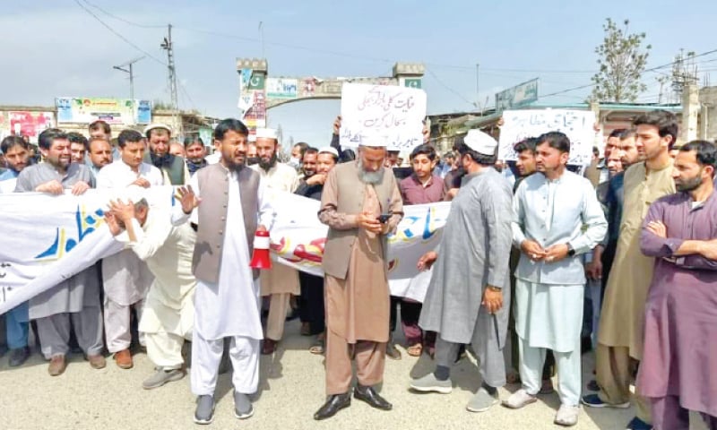 Traders stage a protest in Inayat Kallay Bazaar, Bajaur, on Monday. &mdash; Dawn