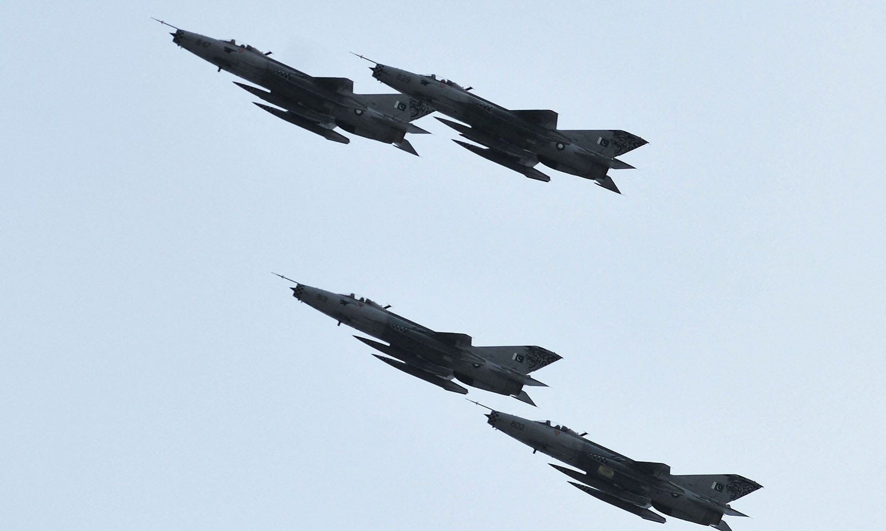 PAF fighter jets fly in formation during the parade. — AFP