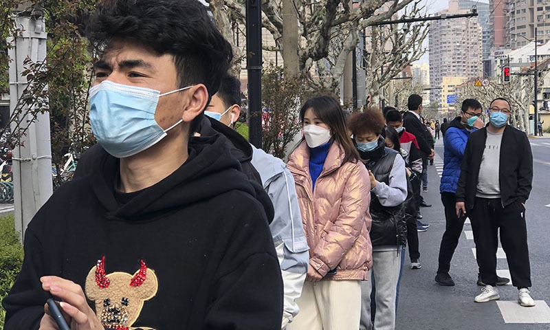 Residents line up for the first round of mass Covid testing in the Jingan district of western Shanghai, China on Friday. &mdash; AP