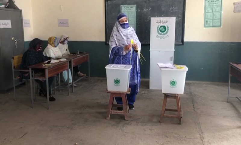 This image shows a woman casting her vote at a polling booth during the second phase of the local government elections in Khyber Pakhtunkhwa on Friday. — DawnNewsTV