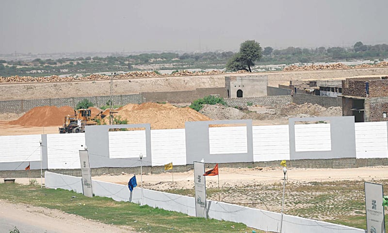 WORK in progress on a housing scheme close to the main dyke of the Indus River.—Dawn