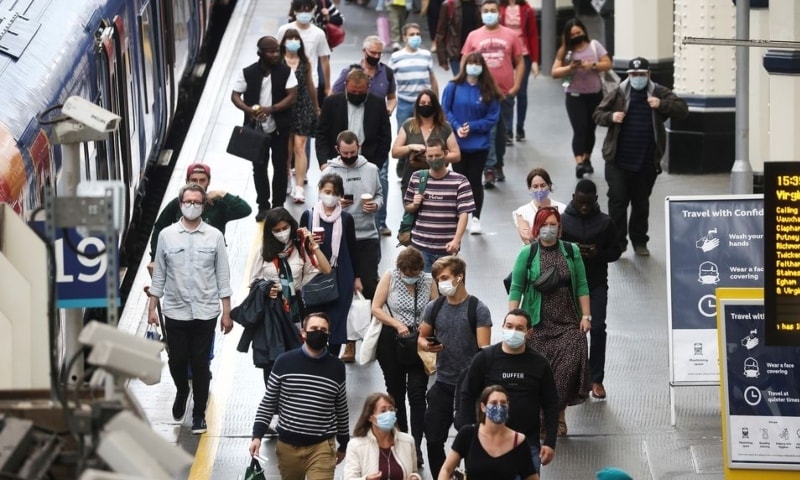 People, some wearing protective face masks, walk through Waterloo Station, amid the coronavirus disease pandemic, in London, on July 4, 2021. — Reuters